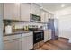 This kitchen features gray cabinetry, stainless steel appliances, and granite countertops at 4204 Sandstone Dr, Mead, CO 80504