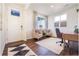 A stylish home office with neutral colors, a cozy seating area, and a functional desk at 4204 Sandstone Dr, Mead, CO 80504