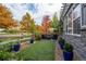 Beautiful backyard with artificial grass, stone patio, outdoor seating, and lush landscaping at 1867 W 137Th Ln, Broomfield, CO 80023
