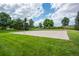Community basketball court surrounded by lush green grass and mature trees, perfect for outdoor recreation at 1867 W 137Th Ln, Broomfield, CO 80023