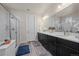 Bright bathroom featuring a glass shower, double sink vanity, and decor at 1867 W 137Th Ln, Broomfield, CO 80023