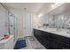 Elegant bathroom with double sinks, dark cabinetry and a walk-in shower at 1867 W 137Th Ln, Broomfield, CO 80023