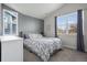 Bright bedroom featuring a grey accent wall, and large windows at 1867 W 137Th Ln, Broomfield, CO 80023