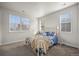 Bright bedroom featuring a white bed frame, large windows, and carpeted floors at 1867 W 137Th Ln, Broomfield, CO 80023