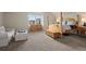 Spacious bedroom featuring a four-poster bed frame, dresser, and sitting area at 1867 W 137Th Ln, Broomfield, CO 80023