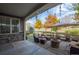Relaxing covered patio area featuring outdoor furniture, string lights, and a charming stone fire pit at 1867 W 137Th Ln, Broomfield, CO 80023