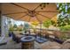 Inviting covered patio with ample seating, a fire pit, and a large umbrella for shade at 1867 W 137Th Ln, Broomfield, CO 80023