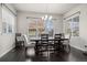 Bright dining room featuring hardwood floors, a modern chandelier and a large window with neighborhood views at 1867 W 137Th Ln, Broomfield, CO 80023