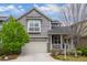 Charming gray two-story home with a well-manicured lawn and inviting front porch at 1867 W 137Th Ln, Broomfield, CO 80023