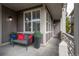 Inviting covered porch with comfortable seating, decorative planters, and stylish outdoor lighting fixtures at 1867 W 137Th Ln, Broomfield, CO 80023