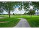 Picturesque view of the community golf course with manicured green lawns and a paved path at 1867 W 137Th Ln, Broomfield, CO 80023