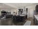 Open-concept kitchen with dark cabinets, stainless steel appliances, and a large island flowing into the living area at 1867 W 137Th Ln, Broomfield, CO 80023