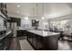 Modern kitchen with large island, stainless steel appliances, and dark cabinetry at 1867 W 137Th Ln, Broomfield, CO 80023