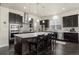 Stylish kitchen with dark cabinetry, stainless steel appliances, a large island with seating, and a mosaic backsplash at 1867 W 137Th Ln, Broomfield, CO 80023