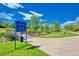 Entrance to The Lake Link Trail with lush greenery, a wooden bridge, and blue skies above at 1867 W 137Th Ln, Broomfield, CO 80023