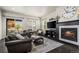 Living room with fireplace, hardwood floors, and view of backyard at 1867 W 137Th Ln, Broomfield, CO 80023