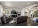 Cozy living room featuring dark hardwood floors, a fireplace, comfortable seating, and stylish decor at 1867 W 137Th Ln, Broomfield, CO 80023