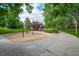 Community playground featuring a swing set and colorful play structure surrounded by lush greenery at 1867 W 137Th Ln, Broomfield, CO 80023
