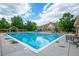 Community swimming pool with lounge chairs and shaded areas at 1867 W 137Th Ln, Broomfield, CO 80023