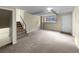 Spacious finished basement with neutral carpeting and an exterior access door at 10547 Pompey Way, Northglenn, CO 80234
