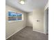 Cozy bedroom with neutral walls, carpet, and a window offering natural light at 10547 Pompey Way, Northglenn, CO 80234