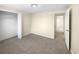 Bright bedroom with neutral walls, carpet, and access to hallway at 10547 Pompey Way, Northglenn, CO 80234