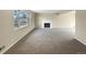 Spacious living room with neutral carpeting and a fireplace at 10547 Pompey Way, Northglenn, CO 80234