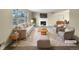 Virtually staged living room featuring neutral tones and a cozy fireplace at 10547 Pompey Way, Northglenn, CO 80234