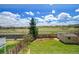 Scenic backyard with vibrant green grass, wood fencing, mature trees, and storage shed at 10704 Moore St, Broomfield, CO 80021