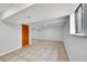 Unfinished basement features tile floors, natural light, and built in bookshelf at 10704 Moore St, Broomfield, CO 80021