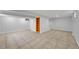 Finished basement featuring tile flooring and built-in shelving at 10704 Moore St, Broomfield, CO 80021