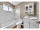 Bathroom features include a tub and shower combination, storage shelf, and white vanity at 10704 Moore St, Broomfield, CO 80021