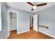 Well-lit bedroom with hardwood floors, ceiling fan, and two closets for ample storage at 10704 Moore St, Broomfield, CO 80021