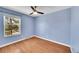 Bedroom featuring a ceiling fan, hardwood floors, and natural light from the window at 10704 Moore St, Broomfield, CO 80021
