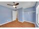Bedroom featuring hardwood floors, a ceiling fan, and an open closet area at 10704 Moore St, Broomfield, CO 80021