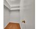 Walk-in closet featuring hardwood floors and shelving at 10704 Moore St, Broomfield, CO 80021