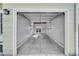 Spacious, open garage with concrete floor, work bench and storage shelves at 10704 Moore St, Broomfield, CO 80021
