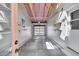Open garage with concrete floor, work bench and storage shelves, and overhead door at 10704 Moore St, Broomfield, CO 80021