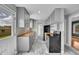 Updated kitchen with open shelving, stainless appliances, butcher block countertops, and marble tile flooring at 10704 Moore St, Broomfield, CO 80021