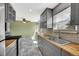 Open kitchen with marble floors, gray cabinets, butcher block countertops, stainless appliances, and ceiling fan at 10704 Moore St, Broomfield, CO 80021