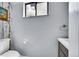 Cozy powder room featuring wood-themed wallpaper, contemporary fixtures, and natural light at 10704 Moore St, Broomfield, CO 80021