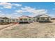 Exterior view of homes, showcasing decks and a spacious backyard setting under a sunny sky at 4331 Soapberry Pl, Castle Rock, CO 80108