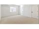 Spacious bedroom with a window, neutral carpeting, and two doors at 4331 Soapberry Pl, Castle Rock, CO 80108