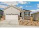 Charming home with a two-car garage, stone accents, landscaped front yard and beautiful white exterior at 4331 Soapberry Pl, Castle Rock, CO 80108