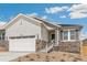 Charming home with a two-car garage, stone accents, landscaped front yard and beautiful white exterior at 4331 Soapberry Pl, Castle Rock, CO 80108