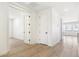 Hallway with hardwood floors and white doors at 4331 Soapberry Pl, Castle Rock, CO 80108
