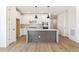 Bright kitchen featuring wood flooring, island, white cabinets, and modern stainless steel appliances at 4331 Soapberry Pl, Castle Rock, CO 80108