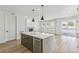 Kitchen island with quartz countertop, stainless steel appliances, and hardwood floors at 4331 Soapberry Pl, Castle Rock, CO 80108