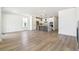 Open-concept living area with wood floors, fireplace, and connected kitchen with modern island at 4331 Soapberry Pl, Castle Rock, CO 80108