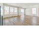 Bright living room featuring wood flooring, large windows, and access to the outdoor deck at 4331 Soapberry Pl, Castle Rock, CO 80108